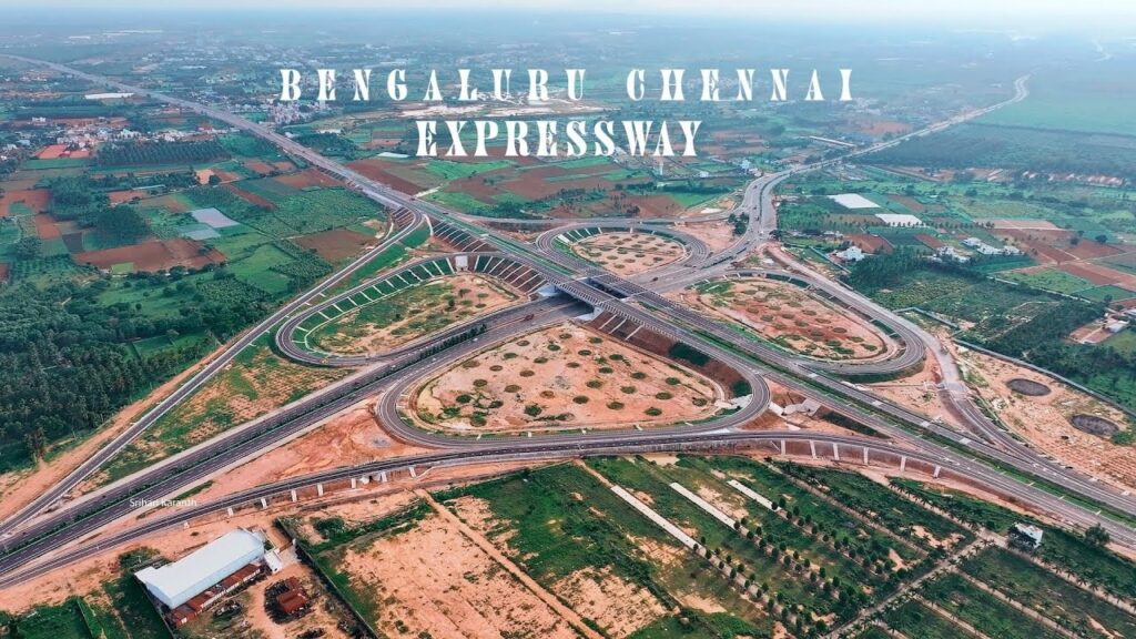 Bengaluru-Chennai Expressway: Revolutionizing Travel and Connectivity The Bengaluru-Chennai Greenfield Expressway is poised to transform the connectivity and economic landscape between these two major cities. Spearheaded by the Union Road Transport Ministry, this ambitious project will significantly reduce travel time and fuel consumption, enhancing regional development and industrial growth. Significance of the Bengaluru-Chennai Expressway The newly constructed Bengaluru-Chennai expressway is ready for inauguration, as confirmed by Union Road Transport Minister Nitin Gadkari. This state-of-the-art national highway, built at a cost of ₹17,930 crores, is expected to be fully operational by the end of this year. With this expressway, the travel time between Bengaluru and Chennai will be slashed to just five hours, a significant improvement over the previous travel duration. Key Features and Construction Phases The expressway spans 262 kilometers, with 110 kilometers falling within Karnataka, while the remainder traverses Andhra Pradesh and enters Tamil Nadu. This four-lane highway will facilitate seamless travel and support the development of industrial corridors along its route. Phase One: Hoskote to Bethamangala The first phase covers a distance of 62.6 kilometers, connecting Hoskote in Bengaluru to Bethamangala in Karnataka. This stretch will feature advanced road infrastructure to ensure smooth and efficient transportation. Phase Two: Bethamangala to Gudipala The second phase extends over 85 kilometers from Bethamangala to Gudipala in Andhra Pradesh. This segment is crucial for integrating regional connectivity and boosting economic activities along the route. Phase Three: Gudipala to Sriperumbudur The final phase spans 106 kilometers, connecting Gudipala to Sriperumbudur in Tamil Nadu. This stretch will further enhance connectivity to Chennai, promoting industrial growth and regional development. Industrial Development Along the Expressway The expressway will foster the development of industrial zones along its route. Significant areas such as Narsapura, Kolar, Mulbagal, and Tamaka have already witnessed industrial growth, thanks to the enhanced transportation infrastructure. These zones are expected to thrive further, attracting investments and generating employment opportunities. Strategic Connectivity and Infrastructure Enhancements The expressway is designed to ensure vehicles can travel uninterrupted, thanks to strategically placed ring roads and flyovers. These include connections from Hoskote to Devanahalli, Hosur, and Tumkur, among others. The infrastructure development extends to direct routes from industrial areas to Kempegowda International Airport, facilitating efficient transportation of goods and passengers. Environmental and Economic Benefits