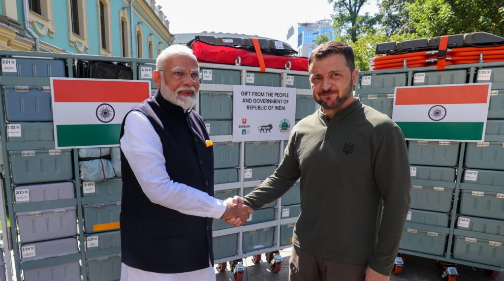 Narendra Modi's Bharat Health Initiative for Sahyog Hita & Maitri (BHISHM): A Game-Changer in Global Medical Aid India's Prime Minister, Narendra Modi, has unveiled a groundbreaking initiative known as the Bharat Health Initiative for Sahyog Hita & Maitri (BHISHM). This innovative program is designed to ensure the rapid deployment of medical facilities and aid on a global scale. The initiative, highlighted by its use of modular "BHISHM cubes," promises to revolutionize the way medical care is delivered in times of need. BHISHM: A New Paradigm in Medical Aid The BHISHM initiative is a unique approach that addresses the challenges of providing medical care in emergency situations. At its core are the BHISHM cubes—compact, modular units that contain essential medicines and medical equipment. These cubes are designed for easy transport and swift deployment, making them an invaluable asset in crisis situations, whether due to natural disasters, pandemics, or conflicts. The Structure and Purpose of BHISHM Cubes Each BHISHM cube is meticulously organized to include a wide range of medical supplies tailored to various emergencies. These cubes are not just about providing basic first aid; they are equipped with advanced medical tools, life-saving drugs, and other critical healthcare resources. The versatility of these cubes allows them to be used in diverse scenarios, from field hospitals in war zones to rural clinics in disaster-stricken areas. The design of the cubes ensures that they can be deployed rapidly, even in the most challenging conditions. Whether it's an earthquake in a remote region or a sudden outbreak of disease in an urban area, BHISHM cubes can be quickly mobilized to provide immediate relief. A Symbol of Global Solidarity Narendra Modi's presentation of BHISHM cubes to Ukrainian President Volodymyr Zelenskyy is a powerful symbol of India's commitment to global solidarity. This gesture underscores the initiative's broader goal: to foster international cooperation in health care. By sharing these resources with Ukraine, India is not only providing essential medical aid but also strengthening diplomatic ties and mutual support between the two nations. The Global Impact of BHISHM The BHISHM initiative is poised to have a significant impact on global health. With its ability to be deployed anywhere in the world, it offers a solution to some of the most pressing healthcare challenges faced by many countries. The initiative aligns with global health goals, particularly in terms of improving access to quality medical care in underserved regions. Moreover, BHISHM reflects India's growing role as a leader in global health. By offering this innovative solution to the world, India is positioning itself as a key player in international humanitarian efforts. Future Prospects of BHISHM Looking ahead, the success of the BHISHM initiative could pave the way for further innovations in global health care. As more countries adopt similar strategies, we could see a new era of collaboration and shared resources in the face of global health challenges. The initiative also opens up possibilities for further enhancements, such as integrating new technologies into the cubes or expanding the range of medical supplies they carry. Conclusion: A Vision for a Healthier World Narendra Modi's Bharat Health Initiative for Sahyog Hita & Maitri (BHISHM) represents a visionary approach to addressing global health challenges. By focusing on rapid deployment, versatility, and international cooperation, the initiative has the potential to save lives and improve health outcomes around the world. The presentation of BHISHM cubes to President Zelenskyy is just the beginning of what could be a transformative journey in global health care, driven by innovation, compassion, and a commitment to a healthier future for all.