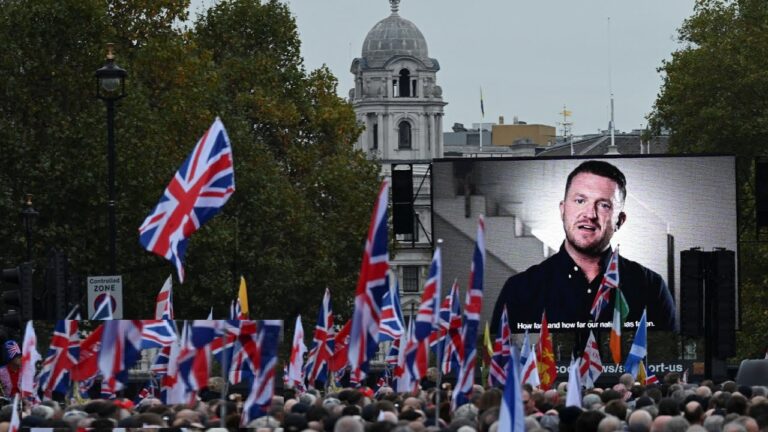 Tommy Robinson, a central figure in the UK's far-right movement, has once again ignited controversy after his recent arrest on contempt charges, sparking widespread protests in London. Over the weekend, thousands gathered to support Robinson under the banner "Unite the Kingdom," demanding his release and rallying for his cause. The event highlights Robinson's ongoing influence within far-right circles in Britain, particularly in discussions surrounding immigration and national identity. The Rise of Tommy Robinson and the English Defence League (EDL) Born as Stephen Yaxley-Lennon, Tommy Robinson is the founder of the English Defence League (EDL), a nationalist group known for its confrontational stance on anti-Islamism and immigration. The recent rally saw a significant turnout, with supporters waving British and English flags and carrying banners echoing "Make America Great Again" – a slogan widely recognized from former U.S. President Donald Trump, who is campaigning for re-election. Trump’s own policies on immigration have inspired similar nationalist sentiments across the globe, including among Robinson's supporters. Counter-Protests Highlight Britain's Divided Views on Immigration The rally in support of Robinson was met by counter-demonstrators organized by the group Stand Up to Racism. These protesters advocated for a more inclusive stance on immigration and condemned Robinson's impact on British society. Nearby, another demonstration by families who had lost loved ones in police custody joined in solidarity with the anti-racism protestors, holding signs that denounced hatred and fascism. The juxtaposition of these rallies reflects the complex social tensions in the UK, as immigration and nationalism continue to stir divisive opinions. Arrests and Escalating Tensions in London As the protests escalated, London's Metropolitan Police made multiple arrests on various charges, including assault and racially aggravated offenses. Among the detained individuals were both supporters and opponents of Robinson, underscoring the volatile atmosphere of the event. One individual was accused of making racist remarks toward a police officer, further highlighting the heated environment. Legal Troubles: Tommy Robinson’s Upcoming Court Appearance Robinson faces an upcoming court date on October 28, where he will answer to accusations of breaching a High Court order from 2021. This court order previously prohibited him from making defamatory statements about a Syrian refugee who won a libel case against him. Robinson's contentious history has led to social media bans, including a Twitter suspension in 2018, though he has since returned to the platform, now known as X. His presence on social media remains strong, attracting a significant following and mobilizing his supporters for his far-right agenda. Protests Amid Rising Immigration Concerns in the UK The backdrop of Robinson's recent arrest is an ongoing national debate on immigration. With recent statistics showing a record number of 29,578 asylum seekers crossing the English Channel this year, many Britons are calling for stricter immigration laws. This influx has fueled tensions and given prominence to far-right activism, as concerns over national identity and resources dominate the public discourse. Robinson’s Message to Supporters: Calls for Unity and Defiance In a recorded message to supporters, Robinson expressed regret at not being able to attend the rally and commended those who gathered for "standing up against the establishment." His message denounced the government, accusing political leaders of hiding truths about national policies and attacking those who oppose them. Robinson framed the event as a moment of "awakening" for British citizens and urged his followers to take political action, emphasizing the need for representation in Parliament that prioritizes the British people. Robinson’s message condemned the government’s handling of immigration, alleging that officials have failed to address the issue of illegal immigration adequately. He also criticized policies affecting British citizens, including cuts to benefits for pensioners and a commitment to achieving net-zero emissions, which he described as a misguided policy threatening the nation’s prosperity. His remarks reflect his ongoing critiques of government agendas, which he argues are influenced by global interests at the expense of British sovereignty. The Divisive Legacy of Tommy Robinson and the Far-Right Movement in the UK The events surrounding Robinson’s arrest and the subsequent demonstrations reveal deep-rooted divides within the UK regarding immigration, national identity, and political authority. As Robinson's legal battle continues, his supporters and detractors will undoubtedly keep voicing their conflicting views, reflecting the polarized climate in British society. In the face of mounting immigration numbers and economic concerns, the national debate is unlikely to wane. The far-right movement, emboldened by figures like Robinson, will likely remain vocal, pushing for stricter immigration policies and a nationalist agenda. Meanwhile, counter-movements will persist in advocating for inclusion and anti-racism, underscoring the complexities of the UK’s political and social landscape.
