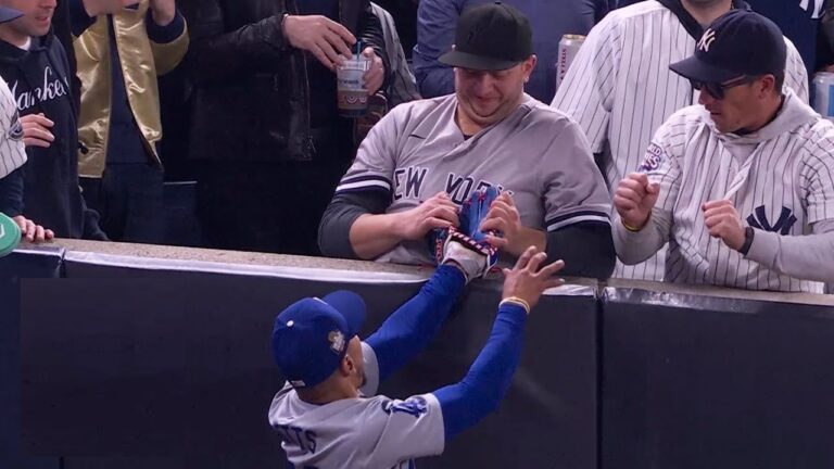 Attempted Fan Interference in the First Inning The game was still young when Yankees fans seated near the foul pole in right field decided to take matters into their own hands. With the Dodgers already leading 2-0 in the bottom of the first inning, Yankees batter Gleyber Torres launched a high fly ball toward the right-field foul line. Betts, racing to make the play, reached the edge of the stands just as the ball descended. As Betts reached up to make the catch, the fans leaned over the railing and attempted to interfere. One fan reached for Betts’ glove, appearing to tug at it in an attempt to force a drop, while another fan tried to push his arm away. Despite these efforts, the Dodgers’ star held onto the ball long enough for the play to be ruled an out. Umpire crew chief Mark Carlson, stationed nearby, quickly called fan interference, awarding the out to Betts. Security Steps In, Fans Escorted Out of Stadium Security personnel at Yankee Stadium wasted no time addressing the situation. Moments after the interference call, stadium security approached the fans involved and escorted them from their seats. Video footage captured the pair being led away from the field and into the concourse area, indicating their likely ejection from the game. Fan interference has been a sensitive issue in professional baseball, particularly in high-stakes games like the World Series. Incidents involving fans attempting to alter the outcome of plays can lead to serious consequences, both for the individuals involved and for the integrity of the game. In this case, the Yankees fans’ actions briefly disrupted the game and earned a quick response from both the umpires and stadium security. Mookie Betts’ Reaction to the Interference Attempt Betts, who successfully prevented the interference from costing his team an out, didn’t hide his frustration. After securing the catch, he shot a frustrated glance at the crowd, visibly displeased by the fans’ attempt to interfere with his play. Betts returned to his position in the outfield, but the incident set the tone for an intense game. As the game resumed, Betts continued to play with focus, undeterred by the fans’ interference attempt. The Dodgers went on to complete the inning, maintaining their lead while the Yankees worked to close the gap. High Stakes for Yankees Fans and World Series Tensions With the Yankees trailing the Dodgers in the World Series, fans at Yankee Stadium were eager to see their team mount a comeback. For some fans, this intensity may have led them to take drastic measures, like the interference attempt on Betts’ play. In the heat of competition, even the most dedicated fans sometimes lose sight of the boundaries, and this incident serves as a reminder of the importance of respecting the players and the game. Consequences and Reactions The fan interference in Game 4 not only disrupted the play but also stirred conversations about the responsibilities of fans in high-stakes environments like the World Series. While fan enthusiasm is part of the excitement of live sports, actions that cross the line can lead to consequences. The ejection of these fans serves as a warning to others that unsportsmanlike conduct is not tolerated. Following the incident, opinions among fans and commentators were mixed. Some felt that the interference showed poor sportsmanship, while others argued it was a momentary lapse in judgment fueled by passion for the game. Nevertheless, the incident raised questions about whether additional measures should be taken to ensure fan behavior remains respectful and within the bounds of the game. Impact on the Yankees’ World Series Hopes Ultimately, the interference call did not significantly alter the course of Game 4, but it underscored the intensity of the rivalry between the Yankees and Dodgers. The Yankees, trailing in the World Series, continued their fight but failed to capitalize on key opportunities in the game. Two runners on base in the first inning, following the interference, ultimately could not bring in any runs, as back-to-back groundouts halted their advance. As the series progresses, both teams and their fans are likely to be under increased scrutiny. The interference incident serves as a reminder that while fan passion is integral to the sport, respect for the game and the players is paramount. Conclusion: A Lesson in Sportsmanship The attempted interference by Yankees fans in Game 4 of the World Series highlights the importance of maintaining respect for players and the game. While fans bring energy and excitement to baseball, crossing the line can impact the flow of the game and reflect poorly on teams and their supporters. This incident is a reminder to fans everywhere: cheer passionately but respect the boundaries of the game.