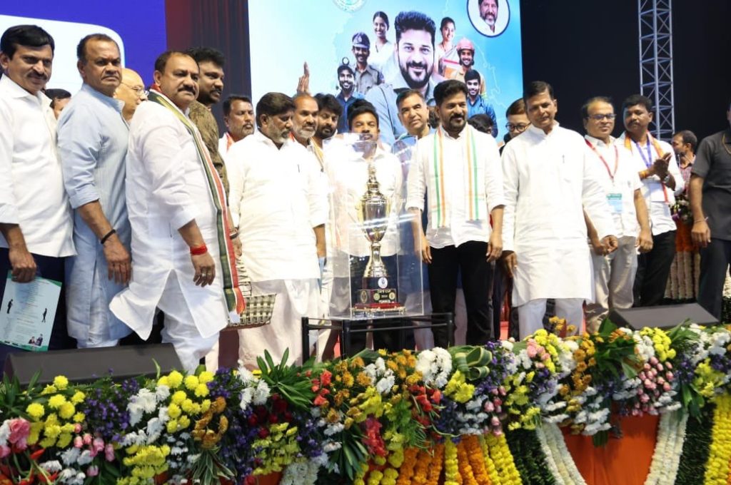The CM Cup 2024 took a significant step forward today with the official launch of the CM Cup Games Management System (GMS), along with the unveiling of the event's jersey, brochure, and trophy. This monumental occasion was part of the Praja Paalana Yuva Vikaasam program held in Peddapalli, where Chief Minister Revanth Reddy presided over the grand event. The highly anticipated games are scheduled to kick off on December 7 and will run until January 2. Strengthening Rural Sports Through the CM Cup The CM Cup 2024 is designed to promote and strengthen rural sports across Telangana. This ambitious event will host 36 sports categories spanning multiple levels, including village, mandal, district, and state. With a focus on encouraging youth participation in sports, the initiative aligns with the broader goals of the Yuva Vikaasam program. Chief Minister Revanth Reddy emphasized the significance of the CM Cup, stating it is not just a formality but a meaningful effort to enhance transparency and efficiency in sports management through digitalization. This initiative is set to revolutionize the way sports are managed and celebrated in the region. Key Highlights of the Games Management System (GMS) The newly launched Games Management System (GMS) is a cutting-edge platform aimed at integrating next-generation digital technology into the CM Cup. Here are its standout features: Athlete Profiles: Comprehensive profiles containing personal and professional details for each athlete. Real-Time Updates: Live updates on match fixtures, schedules, results, scores, and even videos. Instant Communication: Seamless updates to athletes via WhatsApp, including medal tallies and other critical information. Transparency in Sports Administration: The GMS ensures clear, accurate, and timely communication, fostering trust and accountability. By introducing the GMS, the Telangana Sports Authority has set a benchmark for digital innovation in sports, making the CM Cup a pioneer in leveraging technology for effective games management. An Event Marked by High-Profile Participation The launch event witnessed the presence of numerous dignitaries, including Deputy Chief Minister Mallu Vikramarka, various state ministers, and senior officials. Special mention goes to Chairman Shivasena Reddy and Managing Director Smt. Sony Baladevi, who have been instrumental in steering this initiative. Their collective efforts highlight the state's commitment to promoting sports at the grassroots level. A Vision for the Future of Sports in Telangana The CM Cup 2024 is more than just a sporting event—it is a vision to create a robust ecosystem for talent identification, development, and recognition. With the introduction of digital tools like the GMS, athletes can expect a streamlined process that celebrates their achievements and ensures their information is accessible and transparent. Conclusion: Paving the Way for Digital Transformation in Sports As the CM Cup prepares to commence, the integration of the Games Management System underscores a transformative moment in Telangana's sports history. By blending tradition with innovation, the CM Cup is set to inspire countless young athletes and place rural sports on the national map. Mark your calendars for December 7, and witness the spirit of sportsmanship and digital innovation at the CM Cup 2024!