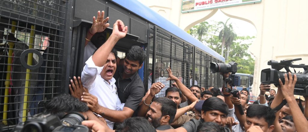 KTR Arrested During Flash Protest at Telangana Assembly Entrance: A Closer Look at Political Tensions Political drama unfolded at the Telangana Assembly on Monday as KT Rama Rao (KTR), the working president of Bharat Rashtra Samithi (BRS), was arrested during a flash protest at the Assembly’s main entrance. The demonstration, which featured fiery slogans and bold political statements, escalated tensions between the ruling party and the opposition. Here’s a detailed look at the unfolding events, the underlying issues, and the implications for Telangana politics. Flash Protest Sparks Arrests at Telangana Assembly The morning began with high drama as KTR, along with several BRS legislators, staged a protest at the Assembly’s entrance. Donning t-shirts emblazoned with the slogan “Revanth-Adani Bhai Bhai,” the protestors targeted alleged connections between Congress leader A Revanth Reddy and industrialist Gautam Adani. Their attire, featuring caricatures of the two figures, served as a bold critique of perceived corporate-political ties. The protest led to a confrontation with the police, who demanded that the legislators remove their provocative t-shirts before entering the premises. Refusing to comply, the BRS leaders defended their actions as a form of free speech. The standoff quickly escalated, resulting in the arrests of KTR and other prominent figures, including opposition MLAs and MLCs such as S Madhusudhana Chari, T Harish Rao, and K Kavitha. Free Speech and Heated Standoff at the Assembly The protest’s central issue revolved around freedom of expression. KTR strongly criticized the police for their actions, questioning their authority to suppress peaceful demonstrations. He highlighted similar protests led by Congress leader Rahul Gandhi as a precedent for legitimacy. During the standoff, opposition members amplified their grievances with slogans like “Adani-Revanth Bhai Bhai,” “Telangana Thalli muddura, Congress Thalli vaddura,” and “Nahi chalega—Thanashahi nahi chalega.” These slogans underscored the growing friction between political entities, reflecting both ideological and cultural clashes. Ultimately, the police detained the demonstrators, escorting them to a nearby station. Despite the arrests, the protest successfully drew public attention to the issues raised by the BRS. BRS Leaders Honor Telangana Martyrs Before Protest Before heading to the Assembly, KTR and his fellow BRS leaders visited the Telangana Martyrs’ Memorial. This gesture aimed to honor those who sacrificed their lives for the statehood movement and highlighted the party’s commitment to preserving Telangana’s identity. Speaking to the media at the memorial, KTR reaffirmed his dedication to addressing public concerns within the Assembly. He vowed to hold the government accountable for unfulfilled electoral promises, stating, “We will not tolerate any attempts to redesign Telangana’s identity or impose Congress Thalli on the people. Such actions undermine the cultural heritage of our state.” Key Issues Behind the Flash Protest The flash protest was not just about slogans and symbolic attire. It brought several critical issues to the forefront: Corporate-Government Allegations The BRS accused Congress leaders of fostering undue ties with corporate entities, specifically highlighting the alleged relationship between Revanth Reddy and Gautam Adani. These accusations aim to position the BRS as a party that prioritizes public welfare over corporate interests. Cultural Identity and Heritage KTR’s statements about the redesign of the Telangana Thalli statue highlighted a deeper cultural issue. The BRS strongly opposed any perceived imposition of Congress ideology on Telangana’s identity, framing the protest as a fight to protect the state’s heritage. Unfulfilled Promises and Accountability By vowing to raise public issues in the Assembly, KTR emphasized the BRS’s role in holding the government accountable. The protest served as a platform to remind voters of the party’s commitment to their interests. Implications for Telangana’s Political Landscape This high-profile protest and subsequent arrests have intensified political tensions in Telangana. The BRS has positioned itself as a vocal opponent of alleged corporate-government collusion and cultural imposition. Meanwhile, the arrests have raised questions about the state’s approach to handling dissent and free speech. The incident also underscores the broader challenges faced by Telangana’s political ecosystem. As the state gears up for elections, such protests are likely to shape public discourse and influence voter sentiment. Conclusion The arrest of KTR and other BRS leaders during the flash protest at the Telangana Assembly marks a significant moment in the state’s political narrative. By addressing critical issues such as corporate influence, cultural preservation, and accountability, the protest has amplified the BRS’s message. As political friction continues to rise, Telangana’s electorate will play a crucial role in determining the outcome of these debates. This incident serves as a reminder of the power of protest in a democracy and the importance of safeguarding free speech, even amid intense political rivalries.