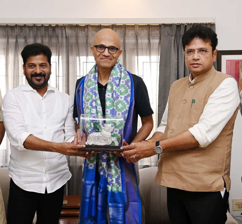sridhar babu revanth reddy with satya nadella at home Historic Meeting Between CM Revanth Reddy and Microsoft CEO Satya Nadella
The meeting between Telangana CM Revanth Reddy and Microsoft CEO Satya Nadella was a big deal. It started a new era of tech partnership between the state and Microsoft. This meeting, where telangana cm meets microsoft ceo, brought together important officials from both sides. They talked about different tech development areas.

The satya nadella revanth reddy meeting happened in Hyderabad. It was a big step in their partnership. They discussed Microsoft investing in Telangana's tech, creating a skilled workforce, and boosting innovation and entrepreneurship.

Key Highlights of the High-Level Discussion
Potential investment in Telangana's tech infrastructure
Development of a skilled workforce
Promotion of innovation and entrepreneurship in the state
Significance of the Meeting for Telangana
This meeting was a big win for Telangana. It was a major step in making the state a tech and innovation hub. The partnership with Microsoft is expected to boost the economy and create jobs.

Venue and Official Proceedings
The meeting took place in a key location in Hyderabad. It marked the start of a new tech partnership era between Telangana and Microsoft. Important officials from both sides were there. They talked about tech development, like infrastructure, talent, and innovation.

Profile: Telangana Chief Minister Revanth Reddy
Telangana Chief Minister Revanth Reddy has been a key player in making the state a tech hub. He aims to build a strong infrastructure and talent pool. This makes Telangana a great place for companies like Microsoft.

The recent meeting between chief minister revanth reddy with satya nadella shows his dedication. He wants to create a place where tech companies can grow and succeed.

Some key highlights of CM Revanth Reddy's achievements include:

Establishing Telangana as a major player in the tech industry
Developing the state's infrastructure to support tech companies
Fostering a talent pool to meet the industry's needs
Under his leadership, Telangana's tech sector has grown a lot. Many big companies have set up shop here. The meeting between chief minister revanth reddy with satya nadella will help the tech industry even more. It will bring new jobs and chances for innovation.

As Telangana grows as a tech hub, CM Revanth Reddy's vision is key. His focus on infrastructure, talent, and working with leaders like Satya Nadella will help Telangana shine globally.