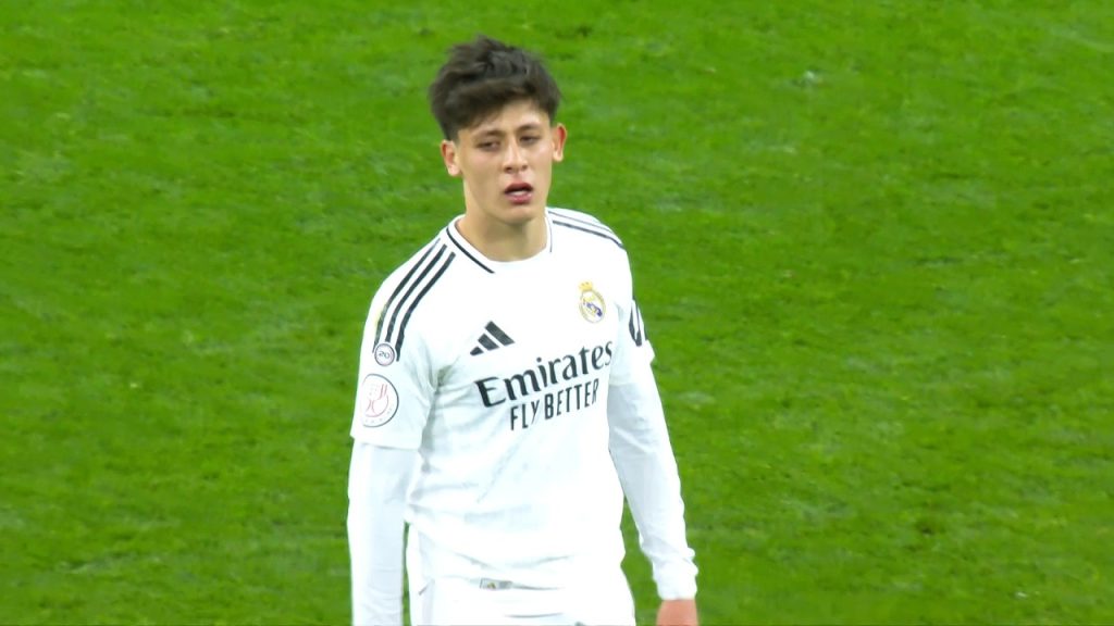 Real Madrid’s Pursuit of La Liga Glory Real Madrid entered the match with their eyes firmly set on closing the gap with league leaders Barcelona. Trailing by seven points with a game in hand, the stakes were high for Carlo Ancelotti’s men. A win against Celta Vigo was non-negotiable to reduce the deficit to four points with only five matches remaining in the season. The Santiago Bernabéu, pulsating with energy, served as the perfect stage for Real Madrid to assert their dominance. The starting lineup reflected Ancelotti’s intent to blend youth and experience. Alongside seasoned stars like Kylian Mbappé, Vinicius Junior, and Jude Bellingham, 20-year-old Arda Güler earned a coveted spot in the first eleven. His inclusion sparked excitement among fans, who eagerly awaited a glimpse of his prodigious talent. Match Overview: Real Madrid vs. Celta Vigo The clash kicked off at 3:00 PM local time, with Real Madrid dictating the tempo from the outset. Celta Vigo, known for their resilience, aimed to frustrate the hosts with a compact defensive setup. However, Real Madrid’s relentless attacking prowess and tactical ingenuity proved too much for the visitors. Goals from Arda Güler and Kylian Mbappé in the first half sealed a 2-0 victory, propelling Real Madrid closer to their La Liga ambitions. Arda Güler’s Moment of Magic The defining moment of the match arrived in the 33rd minute when Arda Güler etched his name into Santiago Bernabéu folklore. Positioned on the right flank of Celta Vigo’s penalty area, Güler received the ball with poise. With a deft touch, he shifted the ball to his left foot and unleashed a curling, pinpoint strike that soared into the far corner. The Santiago Bernabéu erupted as fans marveled at the sheer brilliance of the strike, which commentators dubbed a “spider-web cleaner” for its precision. Güler’s goal was more than just a moment of individual brilliance; it underscored his growing influence within the Real Madrid squad. At just 20, the Turkish midfielder displayed composure and technical mastery that belied his age. His ability to read the game, combined with his flair for the spectacular, has cemented his status as one of Europe’s brightest prospects. Why Güler’s Goal Matters Güler’s strike carried immense significance for both the player and the team. For Güler, it marked a pivotal moment in his La Liga journey, silencing doubters and affirming his readiness for the big stage. For Real Madrid, the goal provided a crucial lead in a tightly contested match, boosting morale and momentum. Fans and analysts alike hailed Güler’s performance as a testament to Real Madrid’s commitment to nurturing young talent. Kylian Mbappé’s Clinical Finish Six minutes after Güler’s opener, Kylian Mbappé doubled Real Madrid’s advantage with a moment of pure class. Capitalizing on a swift counter-attack, Mbappé collected the ball in midfield and embarked on a trademark run. Dribbling past defenders with ease, he reached the edge of Celta Vigo’s penalty area and rifled a low, driven shot into the bottom corner. The goal, scored in the 39th minute, showcased Mbappé’s lethal combination of speed, skill, and precision. Mbappé’s contribution extended beyond his goal. His constant threat on the left flank stretched Celta Vigo’s defense, creating space for teammates like Vinicius Junior and Güler to exploit. The French superstar’s performance reaffirmed his status as a cornerstone of Real Madrid’s attack. Tactical Brilliance: Ancelotti’s Masterplan Carlo Ancelotti’s tactical acumen was on full display throughout the match. Opting for a 4-3-3 formation, Ancelotti prioritized fluidity and attacking intent. The midfield trio of Federico Valverde, Dani Ceballos, and Jude Bellingham provided a perfect balance of creativity and defensive solidity, allowing wingers Vinicius Junior and Mbappé to wreak havoc. Arda Güler’s deployment on the right wing proved a stroke of genius. His ability to cut inside and link up with Bellingham and Mbappé added an unpredictable dimension to Real Madrid’s attack. Meanwhile, defenders Lucas Vázquez and Aurélien Tchouaméni ensured stability at the back, thwarting Celta Vigo’s sporadic counter-attacks. Key Moments of the Match The match was a rollercoaster of action, with several standout moments that kept fans on the edge of their seats. Below is a detailed breakdown of the key events: First Half: Real Madrid’s Dominance 1st Minute: The match kicked off with Real Madrid asserting early pressure, signaling their intent to control proceedings. 4th Minute: Vinicius Junior dazzled on the left, delivering a pinpoint cross to Arda Güler. The young Turk attempted an audacious volley from just behind the penalty spot, but the ball sailed narrowly wide. 8th Minute: Güler’s corner found Tchouaméni in the box, whose towering header flew just over the bar. Real Madrid’s set-piece threat was evident. 33rd Minute: Arda Güler’s moment of brilliance gave Real Madrid the lead, igniting the Santiago Bernabéu. 39th Minute: Mbappé’s sensational solo effort doubled Real Madrid’s advantage, effectively putting the game beyond Celta Vigo’s reach. The first half concluded with Real Madrid firmly in control, leading 2-0. Celta Vigo struggled to create meaningful chances, with goalkeeper Thibaut Courtois enjoying a relatively quiet afternoon. Second Half: Consolidating the Lead The second half saw Real Madrid adopt a more measured approach, focusing on possession and game management. Celta Vigo, desperate to claw their way back, pushed forward but lacked the cutting edge to breach Real Madrid’s defense. Ancelotti introduced fresh legs in the form of substitutes, ensuring his side maintained their intensity until the final whistle. Starting Lineups: A Blend of Youth and Experience Real Madrid Goalkeeper: Thibaut Courtois Defenders: Lucas Vázquez, Aurélien Tchouaméni, Raúl, Francisco García Midfielders: Federico Valverde, Dani Ceballos, Arda Güler, Jude Bellingham Forwards: Kylian Mbappé, Vinicius Junior Ancelotti’s decision to start Güler paid dividends, while the inclusion of young defenders like Raúl and Francisco García highlighted Real Madrid’s depth. Celta Vigo Goalkeeper: Vicente Guaita Defenders: Javier Rodríguez, Yoel Lago Amil, Marcos Alonso, Sergio Carreira Midfielders: Hugo Sotelo, Fran Beltrán, Óscar Mingueza Forwards: Fernando López González, Alfon González, Borja Iglesias Celta Vigo’s lineup featured a mix of experienced players like Marcos Alonso and young talents like Hugo Sotelo, but they struggled to match Real Madrid’s intensity. The Santiago Bernabéu Atmosphere The Santiago Bernabéu was a cauldron of noise and passion, with over 80,000 fans creating an electric atmosphere. Arda Güler’s goal sent the stands into raptures, with supporters chanting his name in unison. The stadium’s iconic architecture and rich history added to the occasion, making it a memorable day for players and fans alike. Why the Bernabéu Remains a Footballing Mecca The Santiago Bernabéu is more than just a stadium; it’s a symbol of Real Madrid’s storied legacy. Home to countless historic moments, the venue continues to inspire players to deliver performances of the highest caliber. Güler’s goal will undoubtedly join the annals of Bernabéu folklore, further cementing its status as a footballing cathedral. Arda Güler: A Star in the Making Arda Güler’s rise to prominence has been nothing short of meteoric. Since joining Real Madrid from Fenerbahçe in 2023, the Turkish prodigy has drawn comparisons to legends like Mesut Özil and Kaká. His vision, technical ability, and knack for delivering in big moments have endeared him to fans and coaches alike. Güler’s Journey to La Liga Stardom Born in Ankara, Güler began his career at Fenerbahçe, where he quickly established himself as one of Turkey’s brightest talents. His move to Real Madrid at the age of 18 was a bold step, but Güler has embraced the challenge with aplomb. Despite early injury setbacks, his performances in the 2024-2025 season have showcased his immense potential. What’s Next for Güler? With his stock rising, Güler is poised to play a pivotal role in Real Madrid’s quest for domestic and European glory. His versatility—capable of playing as a winger, attacking midfielder, or central midfielder—makes him a valuable asset. As he continues to develop, Güler could become a cornerstone of Real Madrid’s future. Real Madrid’s La Liga Ambitions The victory over Celta Vigo keeps Real Madrid’s La Liga hopes alive. With five matches remaining, every point is crucial in their pursuit of Barcelona. Ancelotti’s side will need to maintain their form and capitalize on any slip-ups from their rivals to clinch the title. Upcoming Fixtures Real Madrid’s next few matches will test their mettle: Matchday 35: Away vs. Valencia Matchday 36: Home vs. Atlético Madrid Matchday 37: Away vs. Real Sociedad Matchday 38: Home vs. Getafe Each game presents unique challenges, but Real Madrid’s squad depth and attacking firepower make them formidable contenders. Celta Vigo’s Struggles For Celta Vigo, the defeat highlighted their ongoing struggles in La Liga. Despite moments of promise, they lacked the quality to trouble Real Madrid. Manager Claudio Giráldez will need to rally his troops to avoid being dragged into a relegation battle in the season’s final weeks. Areas for Improvement Celta Vigo’s defense was exposed by Real Madrid’s pace and movement, while their attack failed to test Courtois. Addressing these deficiencies will be critical if they are to finish the season strongly. The Bigger Picture: La Liga’s Competitive Landscape The 2024-2025 La Liga season has been a thrilling affair, with Barcelona, Real Madrid, and Atlético Madrid locked in a fierce battle for supremacy. Emerging talents like Arda Güler, alongside established stars like Mbappé and Robert Lewandowski, have elevated the league’s global appeal. Why La Liga Remains a Powerhouse La Liga’s blend of tactical innovation, technical brilliance, and passionate fanbases makes it one of the world’s premier football leagues. Matches like Real Madrid vs. Celta Vigo exemplify the drama and excitement that define the competition.