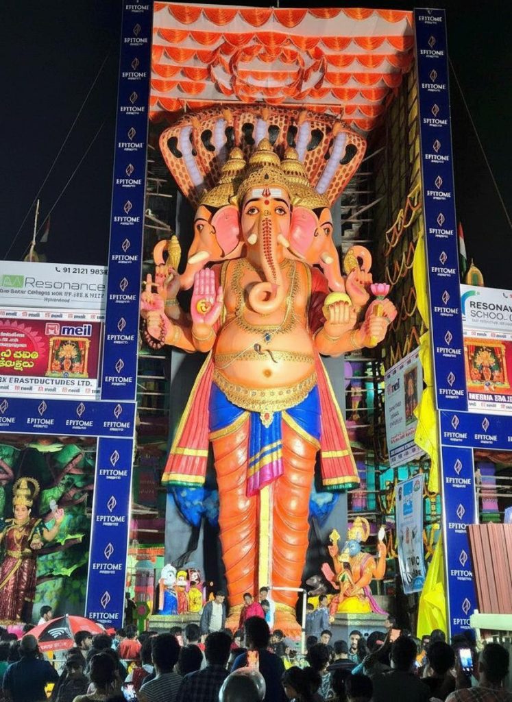 Khairatabad Ganesh 2025: Puja Timings, Aagaman Date, Laddu Auction & Travel Guide Hey there, folks! As someone who's been covering festivals in Hyderabad for over a decade now, I've seen the Khairatabad Ganesh celebrations grow from a local favorite into this massive, city-wide spectacle that draws millions. Picture this: back in 2015, I was dodging crowds to get a glimpse of the idol, which was "only" about 60 feet tall then. Fast forward to today, and the 2025 edition has me buzzing with excitement all over again. The Khairatabad Ganesh 2025 idol stands at an impressive 69 feet, themed as Sri Viswa Shanti Mahashakti Ganapathi, symbolizing world peace and power. It's not just bigger; it's a reminder of how traditions evolve while staying rooted in devotion. If you've ever felt that electric vibe during Ganesh Chaturthi in Hyderabad, you know what I mean— the chants, the lights, the sheer energy. In this guide, I'll walk you through everything you need for Khairatabad Ganesh 2025: from puja timings and the aagaman date to laddu auction details, travel tips, parking hacks, darshan passes, and even eco-friendly highlights. Whether you're a local or visiting from afar, I've got personal tips from my years of navigating these crowds to make your experience smooth and memorable. Khairatabad Ganesh 2025 Highlights Let me start by painting a picture of what makes Khairatabad Ganesh 2025 stand out. This year, the idol is 69 feet tall, crafted meticulously over 84 days by around 125 artisans under the guidance of chief sculptor Chinnaswamy Rajendran, who's been involved since 1978. The theme, Vishwashanti Mahashakti Ganapati, embodies peace and strength, which feels especially relevant in our fast-paced world. I remember one year when the theme was about environmental harmony, and it sparked conversations among devotees— this one's got that same thoughtful vibe. The aagaman, or arrival and unveiling, happened on August 26, 2025, with grand celebrations that lit up the streets. The festival kicked off on August 27 with the first pooja, and it's running through September 6 for the visarjan. Daily darshan starts early, around 6 AM, and goes late into the night, with special homams and rituals sprinkled throughout. From my experience, the second day—like today, August 28—often includes a homam starting around noon, complete with vibrant decorations and maybe even a VIP visit. I've seen crowds swell by mid-morning, so if you're planning a visit, aim for those quieter slots. One personal insight: the idol's face reveal is always a highlight; this year, with its eco-friendly clay and natural colors, it looks more majestic than ever under the lights. Khairatabad Ganesh 2025 Laddu Distribution & Auction Ah, the laddu—where would Ganesh festivals be without it? The Khairatabad Ganesh laddu has a rich history, starting as a simple offering and evolving into a massive auction event that raises funds for charity. In past years, we've seen laddus weighing up to 25,000 kg, auctioned off for crores. For Khairatabad Ganesh 2025, while exact details are still unfolding, expect a giant laddu around that scale, made with pure ghee, nuts, and devotion. The auction typically happens on the last day before visarjan, around September 5 or 6, drawing bidders from across the state. I once bid on a smaller version during a mini-auction (didn't win, but the thrill was real!), and it's not just about the sweet—it's symbolic of prosperity. Distribution starts daily after poojas, with prasadam given to devotees. On day two, for instance, they've been handing out laddus and other treats non-stop from afternoon onward. Pro tip from my decade of festival hopping: get there post-noon for fresh batches, but wear comfy shoes because the lines can snake around the pandal. This year's event might see record bids, given the buzz, so if you're into philanthropy, keep an eye on local news for auction timings. Travel & Accommodation for Devotees Planning a trip to Khairatabad Ganesh 2025? Trust me, as someone who's lugged camera gear through Hyderabad's traffic for years, preparation is key. If you're coming from out of town, fly into Rajiv Gandhi International Airport and hop on a cab or metro to the city center—it's about 30 km away. For locals or those in Telangana, trains to Hyderabad Deccan or buses via TSRTC are reliable and affordable. Stay-wise, budget options like OYO rooms or lodges near Khairatabad start at around ₹1,500 per night, while premium spots like Taj Deccan or Novotel offer luxury from ₹5,000 upward, with views of the city lights. I've stayed at a mid-range hotel near Hussain Sagar once, and waking up to the festival hum was unbeatable. Book early—rates spike during Chaturthi. For connectivity, the metro's a lifesaver: alight at Khairatabad station, just a short walk to the pandal. Buses from Secunderabad or Charminar are frequent too. One example from my travels: during the 2018 festival, I used the metro to beat a massive jam, arriving in time for the evening aarti. If you're driving, carpool to cut costs and hassle. Parking & Traffic Management Traffic during Ganesh Chaturthi? It's like a game of Tetris, but with horns. For Khairatabad Ganesh 2025, Hyderabad police have rolled out advisories starting August 29 through September 5, with diversions based on crowd flow, especially near NTR Marg and Necklace Road. Avoid four-wheelers if you can; opt for bikes or public transport. Designated parking includes spots behind IMAX near the Ambedkar statue—perfect for quick access. From my experience, parking at Yousufguda or metro lots and walking saves hours. The commissioner himself visited today to review setups, emphasizing CCTV, drones, and joint control centers for safety. Expect moderate congestion, so follow barricades and volunteers. A tip I swear by: use apps like Google Maps for real-time updates, but add 30 minutes buffer. Last year, I parked at a suggested zone and zipped in via a side route—game-changer. Darshan, Pooja, and Shobha Yatra Details Darshan at Khairatabad is pure magic, but timing it right is crucial. Puja timings run daily from 6 AM, with maha harati at 9 PM— that's when the lights dim, and the energy peaks, giving you goosebumps every time. For the 10 days, expect special rituals like homam on day two, and rudraksha mala offerings. Special darshan passes for VIPs are available via organizers, but for general folks, queues form early. The Shobha Yatra on September 6 is the grand finale: a colorful procession to Hussain Sagar for immersion, starting from the pandal and winding through streets with music and dances. I've marched in a few, and the route via Tank Bund is chaotic but exhilarating. Personal insight: if you have kids or elders, go for early morning darshan—there's a "secret" back entry from 6-8:30 AM where crowds are thin, and you can even touch the idol's feet. No passes needed, just show up! Eco-Friendly Initiatives & Idol Theme 2025 Sustainability is big this year, and I'm all for it after seeing pollution post-visarjan in earlier festivals. The Khairatabad Ganesh 2025 idol uses eco-friendly clay from Gujarat, rice husk, and natural dyes—no harmful chemicals. Local NGOs and GHMC are pushing awareness campaigns for green celebrations, like using biodegradable materials for decorations. The theme ties in perfectly, promoting peace through eco-conscious practices. In my 10 years, I've noticed a shift: more devotees opting for clay idols at home, inspired by Khairatabad. Example: one year, I joined a workshop on making eco-ganesh, and it changed how I celebrate. Organizers are also distributing saplings—grab one! Tips for a Safe & Comfortable Visit Safety first, always. Best times? Early mornings or late evenings to dodge peak crowds—avoid noon if you hate heat. Carry water, ID, comfy footwear, and a mask for dust. For visarjan, stay back from the water's edge; I've seen slips happen. With heavy footfall expected, follow police guidelines on electrical safety and overcrowding. My go-to: pack snacks, but enjoy the prasadam stalls. If pregnant or with seniors, use the back entry I mentioned. And hey, capture memories, but respect no-photo zones inside. How to Stay Updated on Khairatabad Ganesh 2025 In this digital age, staying looped in is easy. Follow official Instagram like @khairatabadganesh_official for live updates. Local portals like Sakshi Post, Tupaki English, or Eenadu have real-time coverage. Join WhatsApp groups or Telegram channels for traffic alerts—I've used them to reroute mid-journey. Police handles like @CPHydCity post advisories too. One example: during 2020's muted festivities, social media kept the spirit alive virtually. Wrapping up, Khairatabad Ganesh 2025 is shaping up to be epic with its towering idol, heartfelt rituals, and community vibes. From puja timings to the laddu auction and travel hacks, you've got all you need for an unforgettable visit. Don't wait—plan now to soak in the devotion without the stress. Bookmark this page for the latest on Khairatabad Ganesh 2025, and share your stories in the comments. Jai Ganesh!