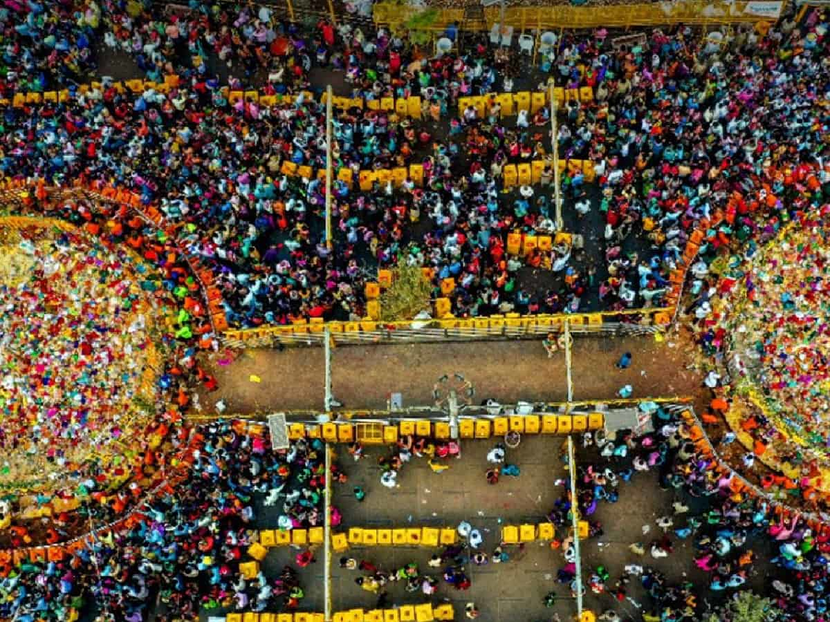Aerial view of the bustling Sammakka Saralamma Jatara festival showcasing the dense crowd and traditional decorations at Medaram temple