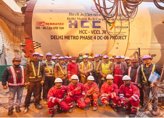 Delhi Metro Phase-IV Corridors to Feature Driverless Trains: A Leap Towards the Future of Urban Transportation The Delhi Metro Rail Corporation (DMRC) has announced a transformative initiative that will redefine urban mobility in India's national capital. The upcoming Phase-IV corridors of the Delhi Metro network will feature state-of-the-art driverless trains, utilizing Unattended Train Operation (UTO) technology to enhance operational efficiency, improve passenger safety, and reduce human intervention in train operations. This ambitious expansion represents a significant milestone in India's journey toward smart, sustainable, and automated public transportation systems.​ India's first driverless metro train was inaugurated by Prime Minister Narendra Modi on December 28, 2020, on the Magenta Line connecting Janakpuri West to Botanical Garden. Since this historic launch, DMRC has steadily expanded its automated fleet, with 69 driverless trains currently operational across the Pink Line and Magenta Line corridors. The introduction of driverless operations on Phase-IV corridors marks the next chapter in Delhi Metro's technological evolution, positioning it to become the world's second-largest driverless metro network with approximately 160 kilometers of fully automated corridors upon completion.​ Driverless Delhi Metro train operating on elevated tracks of the Pink Line amid urban surroundings Understanding Unattended Train Operation Technology Advanced Communication-Based Train Control Systems Driverless metro trains operate using sophisticated Unattended Train Operation (UTO) technology, which represents the highest level of automation in rail transportation. This system is classified as Grade of Automation 4 (GoA4) according to international standards defined in IEC 62290-1:2014. At this level of automation, trains can perform all operational functions without any onboard personnel, including starting, accelerating, decelerating, stopping at stations, and conducting safety diagnostics.​​ The technological foundation of driverless operations rests on Communication-Based Train Control (CBTC) systems, which utilize wireless communication technology to transmit real-time data between trains and track equipment. Unlike traditional fixed signal systems that rely on physical signals along railway tracks, CBTC employs continuous bidirectional communication between trains and wayside control centers. This advanced signaling architecture enables precise train location determination with high resolution, independent of traditional track circuits.​ The CBTC system architecture comprises several critical components working in seamless coordination. Transponders installed at fixed intervals along the tracks wirelessly transmit location information to onboard receivers as trains pass over them. Combined with speed sensors and automated controllers, trains can determine their exact position and automatically calculate optimal movement parameters. This vehicle-centric approach eliminates artificial train separation constraints and allows for minimal safe distances between consecutive trains, significantly increasing line capacity.​ Operations Control Centre Monitoring All driverless train operations are continuously monitored 24/7 by professionals stationed at the Operations Control Centre (OCC). The OCC provides comprehensive remote visibility and control over the entire metro system, including rolling stock, stations, signals, and tracks, with concourse and platform-level monitoring capabilities. This centralized command hub ensures that automated trains operate safely and efficiently while maintaining the ability to intervene remotely if necessary.​ DMRC commissioned a state-of-the-art integrated OCC at Metro Bhawan in February 2024 specifically to support Phase-IV operations. This advanced control center will manage operations across the entire DMRC network of approximately 415 kilometers of track, 388 trains, and over 300 stations from one unified location. The facility utilizes advanced CCTV monitoring systems that automatically stream relevant camera feeds to the OCC when passenger emergency alarm devices are activated, ensuring rapid response to any incidents.​​ The fail-safe technology integrated into driverless trains automatically brings trains to a complete stop if any technical anomaly is detected, prioritizing passenger safety above all else. This multi-layered safety architecture, combining automated systems with human oversight from the OCC, has proven highly effective in maintaining Delhi Metro's exemplary safety record on existing driverless corridors.​ Delhi Metro Phase-IV Project Overview Priority Corridors Under Construction The Delhi Metro Phase-IV project represents one of the most ambitious urban infrastructure undertakings in India, designed to significantly expand connectivity and reduce traffic congestion across the National Capital Region. The comprehensive expansion plan encompasses six corridors spanning approximately 112.32 kilometers with 44 new metro stations scheduled for completion in phases extending through 2029.​ Three priority corridors are currently under active construction with an expected completion timeline of March 2026, though realistic estimates suggest operational readiness may extend to 2028. These priority corridors include the Majlis Park to Maujpur extension of the Pink Line covering 12.318 kilometers with eight stations, the Janakpuri West to RK Ashram Marg extension of the Magenta Line spanning 28.92 kilometers with 21 stations, and the entirely new Aerocity to Tughlakabad corridor known as the Golden Line, stretching 23.622 kilometers with 15 stations.​ The Janakpuri West to Krishna Park Extension section, measuring 2.8 kilometers, became the first Phase-IV segment to become operational in January 2025, marking a significant milestone for the expansion project. Construction has achieved substantial progress on the Majlis Park to Jagatpur Village stretch of 4.6 kilometers, which includes three new stations at Burari, Jharoda Majra, and Jagatpur Village, with trial runs having commenced in December 2024.​ Additional Approved Corridors Beyond the three priority corridors, Delhi Metro has received government approval for three additional corridors that will further extend the network. The Inderlok to Indraprastha corridor will extend the Green Line by 12.377 kilometers, the Lajpat Nagar to Saket G Block corridor will add 8.385 kilometers to the Golden Line network, and the Rithala to Narela to Nathupur (Kundli) corridor will extend the Red Line by 26.463 kilometers into neighboring Haryana.​ In March 2025, DMRC achieved financial closure for these three remaining corridors through a loan agreement with the Japan International Cooperation Agency (JICA) worth 79,726 million Japanese Yen, approximately ₹4,309.53 crores. This funding will enable tendering work to accelerate, with construction activities scheduled to commence subsequently. The foundation stone for the Rithala-Kundli corridor was laid by Prime Minister Narendra Modi in January 2025, signaling the government's commitment to expanding metro connectivity beyond Delhi's administrative boundaries.​ Workers and tunnel boring machine at the Delhi Metro Phase 4 underground construction site Project Financing and Rolling Stock Procurement The total estimated cost for Delhi Metro Phase-IV stands at approximately ₹24,948.65 crores, with funding arranged through multiple sources. The Japan International Cooperation Agency (JICA) has extended substantial financial support through Official Development Assistance (ODA) loans totaling approximately ₹12,930.914 crores for the priority corridors. The remaining project costs are being shared between the Central Government contributing ₹4,643.638 crores, the Delhi Government and other sources providing ₹7,374.098 crores.​ In October 2022, DMRC awarded a significant contract worth ₹2,631.36 crores to Alstom Transport India for the supply of 312 standard gauge metro coaches comprising 52 six-coach train sets for Phase-IV priority corridors. These trains are being manufactured at Alstom's state-of-the-art facility in Sri City, Andhra Pradesh, supporting India's Make in India initiative. The first driverless train set for Phase-IV arrived at the Mukundpur depot in November 2024, where it underwent statutory certification tests before deployment.​ The 312 coaches are distributed across the three priority corridors as follows: 144 coaches (24 trains) for the Janakpuri West to RK Ashram Marg Magenta Line extension, 90 coaches (15 trains) for the Majlis Park to Maujpur Pink Line extension, and 78 coaches (13 trains) for the new Aerocity to Tughlakabad Golden Line corridor. The Golden Line contract includes comprehensive maintenance services for a period of 15 years, ensuring long-term operational reliability.​ Advanced Features of Phase-IV Driverless Trains Technical Specifications and Design The new Alstom Metropolis train sets for Delhi Metro Phase-IV incorporate cutting-edge technology and passenger-centric design features. These lightweight trains are constructed from stainless steel with a width of 3.2 meters, optimized for standard gauge track systems. Each six-coach train configuration consists of two Driving Motor Cars (DMC) at both ends and four Trailer Cars (TC) in between, providing a balanced distribution of propulsion power and passenger capacity.​ The trains are designed with a maximum speed capability of 95 kilometers per hour and an operational speed of 85 kilometers per hour, ensuring rapid transit across the network while maintaining safety margins. The design essentially mirrors the successful Alstom trains currently operating on Mumbai Metro's Aqua Line, demonstrating proven reliability and performance in Indian operating conditions.​ All Phase-IV trains are equipped with Alstom's advanced CBTC signaling and train control solutions, enabling GoA4 grade automation for fully Unattended Train Operations. This technology allows trains to operate autonomously from depot to passenger service and back, with all critical functions managed by onboard computers communicating continuously with wayside equipment and the central OCC.​ Enhanced Safety Features Platform Screen Doors (PSDs) represent a critical safety innovation being implemented across all Phase-IV stations. These automated barriers create a physical separation between platform areas and train tracks, opening only when trains are properly positioned at stations. Underground stations will feature full-height PSDs measuring 2.15 meters, while elevated stations will be equipped with half-height PSDs similar to those on existing Pink and Magenta Line stations.​​ Metro platform with automatic platform screen doors enhancing passenger safety The implementation of PSDs serves multiple safety objectives beyond preventing accidental falls or suicide attempts. These systems improve climate control within stations by physically isolating platforms from tunnel areas, enhance security by restricting unauthorized access to tracks, reduce littering on track areas, and improve sound quality of platform announcements by minimizing background noise from tunnels. The synchronization of PSDs with train doors ensures smooth boarding and alighting operations while maintaining operational efficiency.​​ Emergency Escape Doors integrated into the PSD system provide critical safety redundancy. These single-leaf hinged doors open toward the platform side and can be manually operated from the track side if a train fails to stop at the correct position, ensuring passenger safety even during system anomalies. The comprehensive safety architecture combining automated train operations, platform screen doors, and emergency protocols establishes multiple layers of protection for passengers.​​ Energy Efficiency and Sustainability Driverless metro operations contribute significantly to environmental sustainability through multiple mechanisms. The automated systems optimize energy consumption by precisely controlling acceleration and braking profiles, eliminating the variability inherent in human operation. Artificial Intelligence algorithms calculate optimal deceleration and acceleration times, allowing trains to start and stop with pinpoint accuracy while minimizing energy expenditure.​ Delhi Metro has earned international recognition for its environmental initiatives, becoming the first railway project in the world certified by the United Nations to receive carbon credits for reducing Greenhouse Gas (GHG) emissions. Through its innovative regenerative braking process, whenever trains apply brakes, three-phase traction motors act as generators producing electrical energy that returns to overhead electricity lines for use by other accelerating trains in the same service line. This system reduces overall electricity requirements by approximately 30 percent.​ The modal shift from private vehicles to metro transportation has resulted in Delhi Metro helping reduce pollution levels in the city by an estimated 630,000 tonnes annually. DMRC currently meets about 35 percent of its total energy needs from renewable sources, primarily solar energy, with an ambitious target to increase this proportion to 50 percent by 2031. The combination of automated operations, regenerative braking, renewable energy utilization, and reduced vehicular emissions positions Delhi Metro as a model for sustainable urban transportation.​ Current Driverless Operations and Future Expansion Magenta and Pink Line Success Stories The Delhi Metro's existing driverless operations on the Magenta and Pink Lines have demonstrated exceptional performance and reliability since their implementation. The Magenta Line achieved full GoA4 unattended operations in May 2025, with all train operators completely removed from the system. This milestone was reached through a carefully phased implementation strategy spanning several years, beginning with the removal of cab partition doors and driving consoles while retaining train operators, progressing to allowing operators anywhere within trains, then reducing operator presence to alternate trains only, and finally eliminating operators entirely.​ The Pink Line commenced its automation journey in March 2025 and reached Stage II by June 2025, with full driverless operations expected within a few months thereafter. Once both lines achieve complete automation, Delhi Metro will operate 97 kilometers of fully driverless corridors out of its total 395-kilometer network in the Delhi-NCR region, positioning it among the world's largest driverless metro systems.​ Currently, 43 driverless trains operate on the Pink Line and 26 on the Magenta Line under the UTO system. According to DMRC officials, the implementation of driverless operations has significantly enhanced operational efficiency by improving coach availability for service and eliminating manual pre-induction inspection processes, thereby reducing the workload on train operators while ensuring smoother service delivery.​ Record-Breaking Ridership Performance The Delhi Metro's reliability and efficiency have driven consistently increasing passenger numbers, demonstrating strong public confidence in the system. On August 8, 2025, DMRC achieved its highest-ever single-day ridership with 8,187,674 passenger journeys recorded across all operational corridors. This milestone surpassed the previous record of 7.87 million journeys set in November 2024. To accommodate the surge in travel demand ahead of the Rakshabandhan festival, DMRC operated 92 additional train trips on August 8 and scheduled 455 extra trips for August 9.​ These impressive ridership figures reflect passengers' growing trust in Delhi Metro's reliability, punctuality, and seamless connectivity across the Delhi-NCR region. The automated operations on driverless corridors have contributed to this success by enabling higher service frequencies, reducing delays caused by human factors, and maintaining consistent schedule adherence. The flexibility of driverless operations allows DMRC to quickly adjust service levels in response to real-time demand, optimizing resource utilization during peak and off-peak periods.​ Path to World's Second-Largest Driverless Network Upon completion of Phase-IV, Delhi Metro will operate driverless trains across extended sections of the Pink and Magenta Lines, as well as the entirely new Golden Line corridor from Aerocity to Tughlakabad. This expansion will result in approximately 160 kilometers of fully automated metro corridors operating under GoA4 standards, establishing Delhi Metro as the world's second-largest driverless metro network after Singapore.​ This remarkable achievement positions Delhi Metro at the forefront of global urban rail automation. Among the elite 7 percent of metro networks worldwide capable of operating trains autonomously, Delhi Metro's extensive driverless infrastructure demonstrates India's technological capabilities and commitment to modernizing public transportation. The success of Delhi Metro's automation initiatives has inspired other Indian cities including Mumbai, Bangalore, and Kolkata to pursue similar driverless technologies for their metro systems.​ Advantages of Driverless Metro Operations Operational Efficiency and Flexibility Driverless train operations deliver substantial improvements in operational efficiency across multiple dimensions. Automated systems eliminate response time variabilities inherent in human control, optimizing running times by increasing average speeds and reducing station dwell times. This enhanced precision enables trains to operate at minimum safe separations, dramatically increasing line capacity without requiring additional infrastructure investments.​ The predictability of automated operations creates unprecedented operational flexibility. Operators can automatically park trains and maintain them in idle mode indefinitely, quickly respond to service changes without requiring human drivers to be constantly present, and seamlessly adjust service frequencies based on real-time demand patterns. During periods of high passenger volume, train lengths can be doubled through automatic coupling controlled remotely from the control center, maximizing capacity utilization.​ Train regulation systems optimize energy consumption and reduce maintenance costs through smoother driving standards and optimal acceleration and braking profiles. The elimination of manual driving variability results in more consistent wear patterns on rolling stock and infrastructure components, extending equipment lifespan and reducing maintenance requirements. These efficiency gains translate directly into lower operational costs, making driverless systems economically attractive despite higher initial capital investments.​ Enhanced Safety and Reliability Automated train operations significantly enhance passenger safety through multiple mechanisms. Advanced monitoring systems equipped with sophisticated sensors and algorithms continuously monitor train operations in real-time, making autonomous decisions faster than human operators to minimize errors and prevent accidents. The elimination of human factors such as fatigue, distraction, or misjudgment removes major sources of operational risk that have historically contributed to railway accidents.​ The fail-safe design philosophy embedded in driverless systems ensures that any detected anomaly automatically triggers protective responses, bringing trains to controlled stops before potentially hazardous situations can develop. Sensor data combined with predictive analytics enables optimized maintenance scheduling, identifying potential equipment failures before they occur and further improving system reliability. The continuous monitoring from the OCC provides an additional safety layer, with human experts able to intervene remotely if automated systems encounter unexpected scenarios.​ The safety record of Delhi Metro's existing driverless operations validates these technological advantages. Since the introduction of UTO services on the Magenta and Pink Lines, these corridors have maintained exemplary safety standards while handling millions of passenger journeys. The integration of platform screen doors with automated train operations creates a comprehensive safety ecosystem that effectively prevents platform accidents, a leading cause of casualties on metro systems worldwide.​​ Environmental and Economic Benefits The environmental advantages of driverless metro operations align closely with India's commitment to achieving net-zero emissions by 2070. Automated trains reduce energy consumption through precise speed control and optimized acceleration/braking profiles, lowering overall carbon footprints by reducing congestion and improving throughput. The regenerative braking systems employed by Delhi Metro recover kinetic energy during deceleration, feeding it back into the electrical grid for use by other trains, resulting in approximately 30 percent energy savings.​ Delhi Metro's modal shift impact demonstrates the broader environmental benefits of efficient public transportation. Every passenger choosing metro over private vehicles contributes to reducing roughly 100 milligrams of carbon dioxide emissions per 10-kilometer trip. The TERI study found that metro rail passengers save about 32.38 grams of CO₂ per kilometer compared to road vehicle travel. With over 8 million daily passenger journeys, the cumulative emission reductions are substantial, contributing meaningfully to air quality improvement in the National Capital Region.​ From an economic perspective, driverless operations reduce long-term operational expenditures through lower staffing requirements, reduced energy costs, optimized maintenance scheduling, and improved asset utilization. While initial capital investments for automation technology are significant, the lifecycle cost advantages become apparent over the 30-40 year operational lifespan of metro systems. The ability to increase service frequencies without proportional cost increases makes driverless systems particularly attractive for high-density urban corridors experiencing growing demand.​ Construction Progress and Engineering Achievements Tunneling Breakthroughs and Innovations Delhi Metro Phase-IV construction has achieved multiple significant tunneling milestones utilizing advanced Tunnel Boring Machine (TBM) technology. In July 2025, DMRC completed a 792-meter underground tunnel between Tughlakabad and Tughlakabad Railway Colony on the Golden Line corridor using a 91-meter-long TBM operating at an average depth of 18 meters. This achievement marked one of several parallel tunnel segments being constructed simultaneously across Phase-IV corridors.​ In June 2025, another major breakthrough occurred at Vasant Kunj Metro Station with the completion of a 1,550-meter tunnel between Kishangarh and Vasant Kunj on the Aerocity-Tughlakabad corridor. This tunnel was excavated at an average depth of 22.86 meters, ranging between 15.48 and 30.25 meters, requiring the installation of 1,105 precast concrete rings with an inner diameter of 5.8 meters. The parallel tunnel on this stretch had been completed in March 2025, demonstrating the coordinated progress across multiple construction packages.​ The longest tunneling drive of Phase-IV was completed by Afcons Infrastructure in late 2024, boring a 2.65-kilometer stretch between Tughlakabad Airforce and Maa Anandmayee Marg station using a 105-meter-long TBM at a depth of 16 meters. This challenging drive required frequent cutter replacements to penetrate hard rock formations, with the tunnel alignment carefully planned to avoid passing beneath heritage structures. The tunnel utilized approximately 1,894 precast tunnel rings manufactured at a mechanized casting yard using steam curing systems to achieve early concrete strength.​ All underground tunneling for Phase-IV employs the Earth Pressure Balancing Method (EPBM), a proven technology that allows controlled excavation through varied soil and rock layers while maintaining ground stability. This technique is particularly valuable for underground construction in densely populated urban areas where minimizing surface disturbance and preventing ground subsidence are critical priorities. Continuous monitoring of ground movement during excavation ensures structural stability and public safety throughout the construction process.​ Overall Project Status As of mid-2025, Delhi Metro Phase-IV construction has achieved approximately 70 percent completion on several critical corridors. The 4.6-kilometer stretch between Majlis Park and Jagatpur Village on the Pink Line extension is approaching completion, with three stations at Burari, Jharoda Majra, and Jagatpur Village nearing readiness. Trial runs on this segment commenced in December 2024, and the section awaits final statutory approvals and safety certifications before opening to passengers.​ Significant progress has been recorded on the Aerocity-Tughlakabad Golden Line corridor, with three major tunnel breakthroughs completed within a two-month period during early 2025. Of the total 65.2 kilometers approved for the priority corridors, approximately 40.1 kilometers comprise underground sections, with the Aerocity-Tughlakabad corridor accounting for 19.34 kilometers of subterranean construction. The remaining portions utilize elevated structures, which generally progress faster than underground segments due to fewer geological constraints.​ While the original deadline for Phase-IV priority corridors was December 31, 2024, DMRC has revised its completion target to March 2026. However, realistic assessments by industry observers suggest that full operational readiness may extend to 2028 due to the complexity and scale of remaining work. The COVID-19 pandemic and subsequent labor shortages significantly impacted construction timelines during 2020-2021, creating delays that continue to influence the project schedule.​ Transforming Urban Mobility in Delhi-NCR Connectivity and Accessibility Improvements Delhi Metro Phase-IV will fundamentally transform urban mobility across the National Capital Region by providing last-mile connectivity to emerging residential and employment hubs. The expansion will add 44 new metro stations across the priority corridors, significantly enhancing accessibility for communities in North, West, South, and East Delhi. Areas such as Burari, Sonia Vihar, Bhajanpura, Vasant Kunj, Chhatarpur, and Tughlakabad will gain direct metro access for the first time.​ The strategic routing of Phase-IV corridors addresses critical connectivity gaps in Delhi's existing metro network. The Golden Line creates a vital north-south link connecting the Violet and Airport Express Lines at their termini, providing seamless access to Indira Gandhi International Airport from southern residential areas. The extended Magenta Line will connect central Delhi's RK Ashram Marg area with western suburbs, improving accessibility for commuters traveling between these regions.​ The 29 existing interchange stations within Delhi Metro's network enable passengers to transfer between lines seamlessly, creating a highly connected transportation web. Phase-IV will further enhance this interconnectivity, allowing commuters to reach virtually any corner of Delhi-NCR through convenient metro connections. This comprehensive coverage encourages modal shift from private vehicles to public transportation, reducing road congestion and improving overall urban mobility.​ Socioeconomic Impact The expansion of Delhi Metro generates substantial socioeconomic benefits extending beyond transportation convenience. Improved connectivity reduces travel times significantly, with Delhi Metro saving an estimated 269 million hours of travel time for passengers annually. This time savings translates directly into enhanced productivity, better quality of life, and increased economic opportunities for residents across the metropolitan region.​ Property values in areas gaining metro connectivity typically experience appreciation as accessibility improves, benefiting homeowners and stimulating real estate development. Commercial activity around metro stations flourishes through increased foot traffic and improved accessibility for customers and employees. The construction phase itself generates significant employment across skill levels, from engineering and technical roles to construction labor, contributing to economic growth.​ The environmental benefits of increased metro ridership extend to public health improvements through better air quality. Delhi's chronic air pollution problems are significantly exacerbated by vehicular emissions, with private vehicles contributing 40-50 percent of the city's air pollution. By encouraging modal shift to metro transportation, Phase-IV will help reduce vehicular emissions, contributing to cleaner air and better health outcomes for Delhi's residents.​ Challenges and Future Outlook Technical and Operational Considerations The implementation of driverless operations on Phase-IV corridors presents technical challenges requiring careful management. The integration of new driverless trains with existing infrastructure and signaling systems demands meticulous planning and extensive testing to ensure seamless operations. The commissioning phase for CBTC systems typically involves substantial work scopes, significant equipment quantities, multiple stakeholders, and complex coordination requirements.​ Cybersecurity emerges as a critical concern for automated metro systems reliant on wireless communications and computer control. The CBTC architecture's dependence on continuous data exchange between trains and wayside equipment creates potential vulnerabilities requiring robust security protocols. DMRC must implement comprehensive cybersecurity measures to protect against potential threats while maintaining system reliability and performance.​ Public acceptance of driverless technology represents another important consideration. While Delhi Metro's existing driverless operations on the Magenta and Pink Lines have built public confidence, some passengers may initially feel uncomfortable boarding trains without visible operators. Clear communication about safety features, continuous OCC monitoring, and the proven track record of existing driverless services will be essential for building public trust.​ Integration with Broader Transportation Ecosystem Delhi Metro Phase-IV must integrate effectively with other transportation modes to maximize its impact on urban mobility. Seamless connections with bus services, auto-rickshaws, cycle-sharing systems, and pedestrian infrastructure are essential for providing true last-mile connectivity. The development of multimodal transportation hubs at major metro stations can facilitate smooth transfers between different transportation modes, encouraging comprehensive public transit adoption.​ The integration of Delhi Metro with regional rail systems serving neighboring states represents a strategic priority for the National Capital Region. Coordinated timetabling, integrated ticketing systems, and physical connectivity between Delhi Metro and rail networks serving Uttar Pradesh, Haryana, and Rajasthan would create a comprehensive regional transportation system. Phase-V planning efforts already envision extending metro connectivity to cities in neighboring states, building on the foundation established by Phase-IV.​ Smart city initiatives provide opportunities for deeper integration of metro operations with urban management systems. Real-time passenger information systems, mobile ticketing applications, and integration with navigation platforms enhance user experience and convenience. Data analytics from automated metro operations can inform urban planning decisions, helping authorities understand travel patterns and optimize transportation infrastructure investments.​ Conclusion The introduction of driverless trains on Delhi Metro Phase-IV corridors represents a transformative advancement in India's urban transportation infrastructure. By implementing cutting-edge Unattended Train Operation technology featuring Communication-Based Train Control systems, platform screen doors, and comprehensive safety protocols, DMRC is establishing new benchmarks for metro operations in India and globally.​ The expansion will add approximately 112 kilometers of new metro lines with 44 stations, significantly enhancing connectivity across Delhi-NCR while positioning Delhi Metro as the world's second-largest driverless metro network with 160 kilometers of fully automated corridors. The operational advantages of driverless systems—including enhanced safety, improved efficiency, greater flexibility, reduced energy consumption, and environmental sustainability—demonstrate the compelling benefits of automation technology.​ With construction progressing steadily toward the revised March 2026 completion target for priority corridors, Delhi Metro Phase-IV promises to revolutionize urban mobility for millions of residents. The successful implementation of driverless operations will serve as a model for other Indian cities pursuing metro automation, contributing to India's broader vision of sustainable, technology-driven urban development.​ As Delhi Metro continues its journey toward becoming a world-class automated metro network, the Phase-IV expansion exemplifies the transformative potential of investing in modern, sustainable public transportation infrastructure. The driverless trains soon to operate across these new corridors will not merely transport passengers—they will carry Delhi-NCR toward a cleaner, more connected, and more efficient urban future.